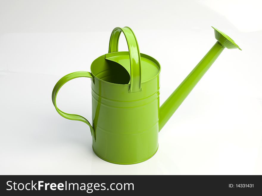 Green watering can on white background