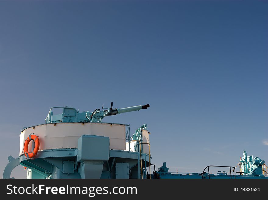 Cannon on blue sky. Old warship from second world war in the Gdynia harbour