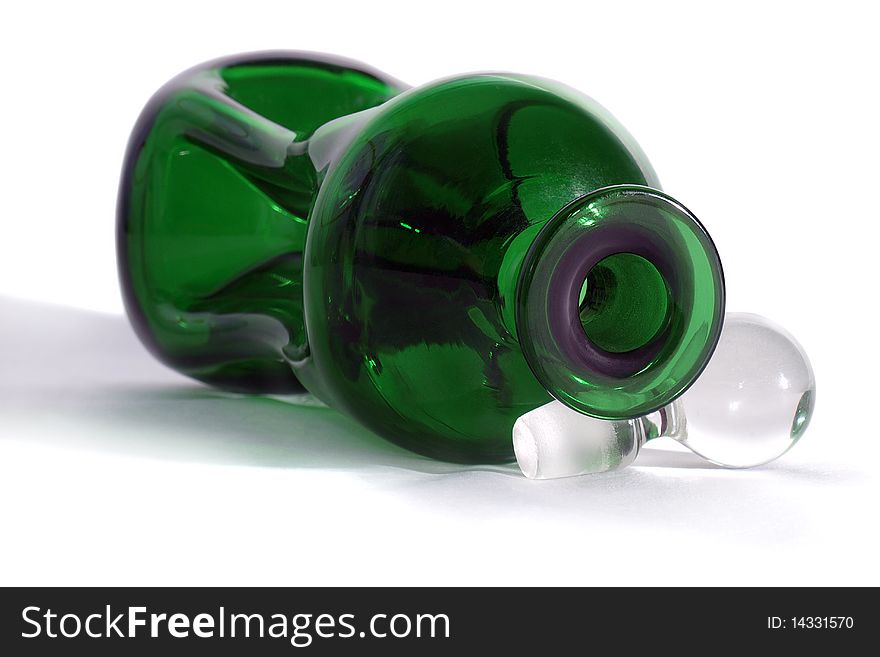The decanter is made of green glass. The decanter is made of green glass