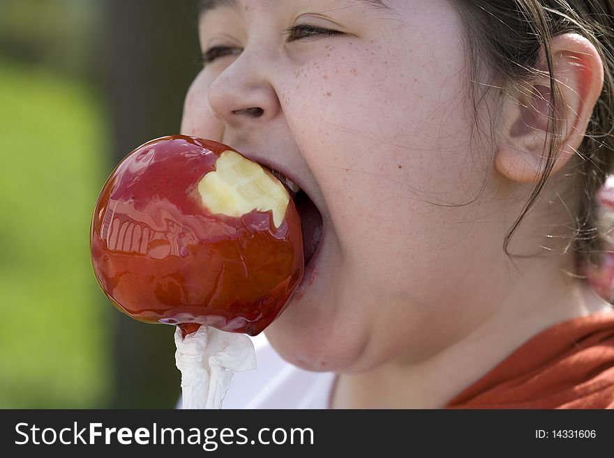Little girl eating apple outdoor. Little girl eating apple outdoor