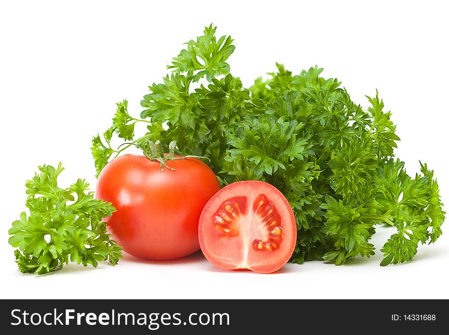 Tomato with parsley on a white background