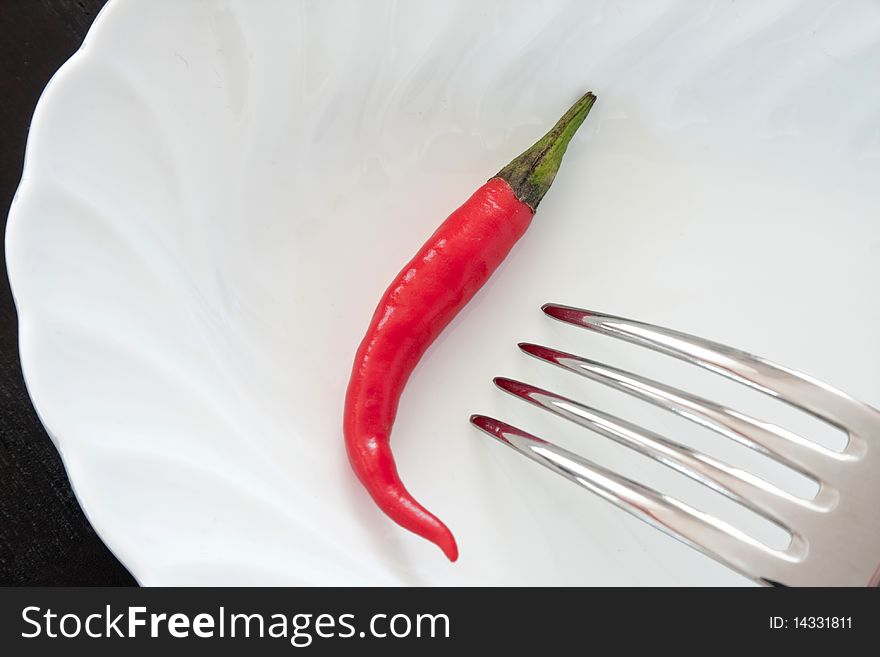 Composition of red chili pepper in white plate