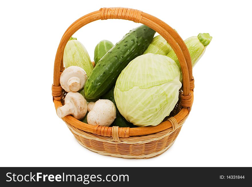 Wattled basket with vegetables isolated on white