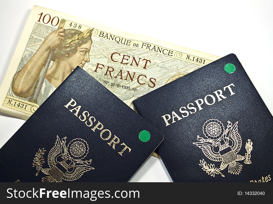 French 100 Franc bank note and 2 passports isolated. French 100 Franc bank note and 2 passports isolated.