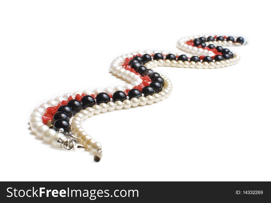 Pearl, agate and coral necklases isolated on white background. Curved like the river or snake. Pearl, agate and coral necklases isolated on white background. Curved like the river or snake