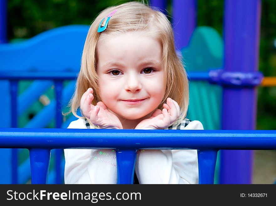 Portrait of a 3 year old girl in playground equipment. Portrait of a 3 year old girl in playground equipment