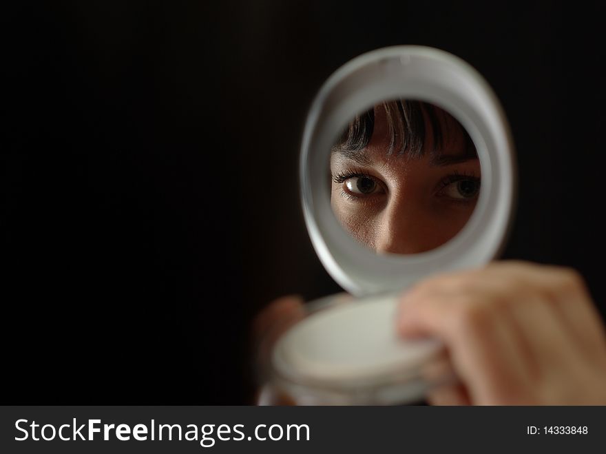 Female face reflected in the mirror