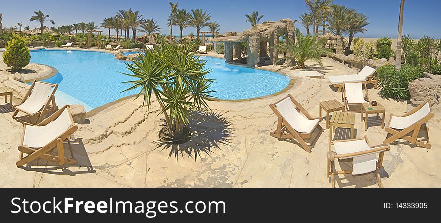 Panoramic view of a swimming pool in a luxury villa at a tropical resort. Panoramic view of a swimming pool in a luxury villa at a tropical resort