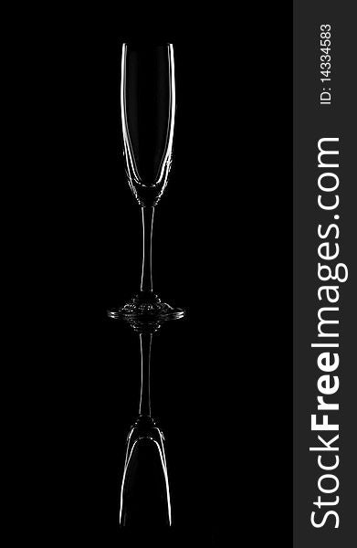 The empty wineglass on black background. Glass dishware.