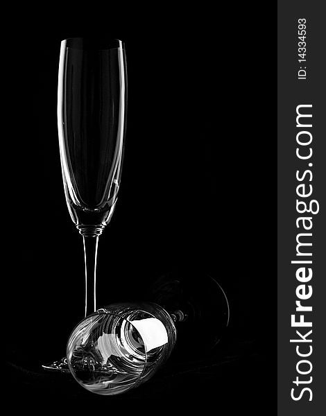 The empty wineglasses on black background. Glass dishware.