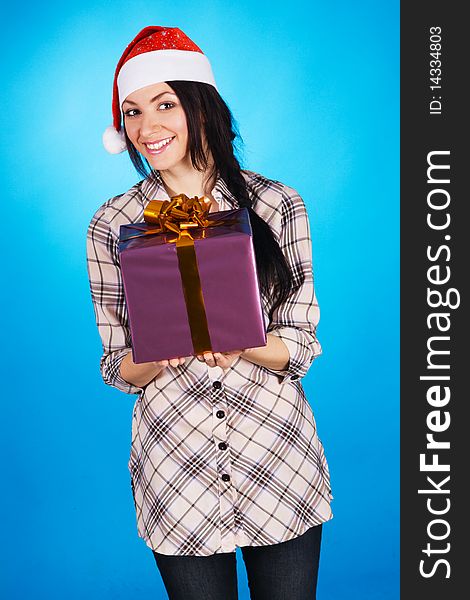 Christmas girl with a gift box, blue background