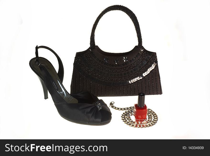 Black shoe, handbag and silver necklace isolated on with background