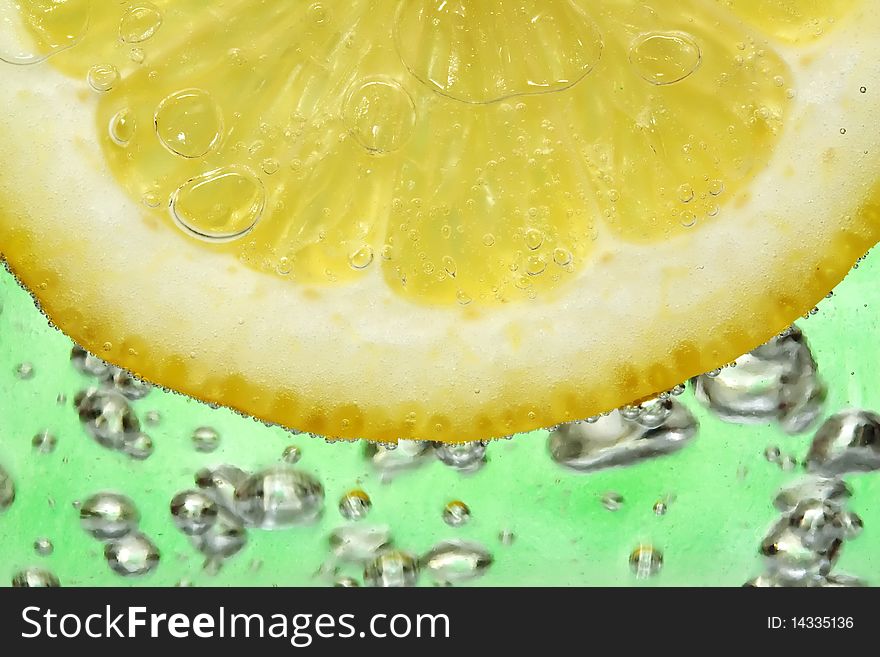 Close up on a lemon slice in a cocktail.