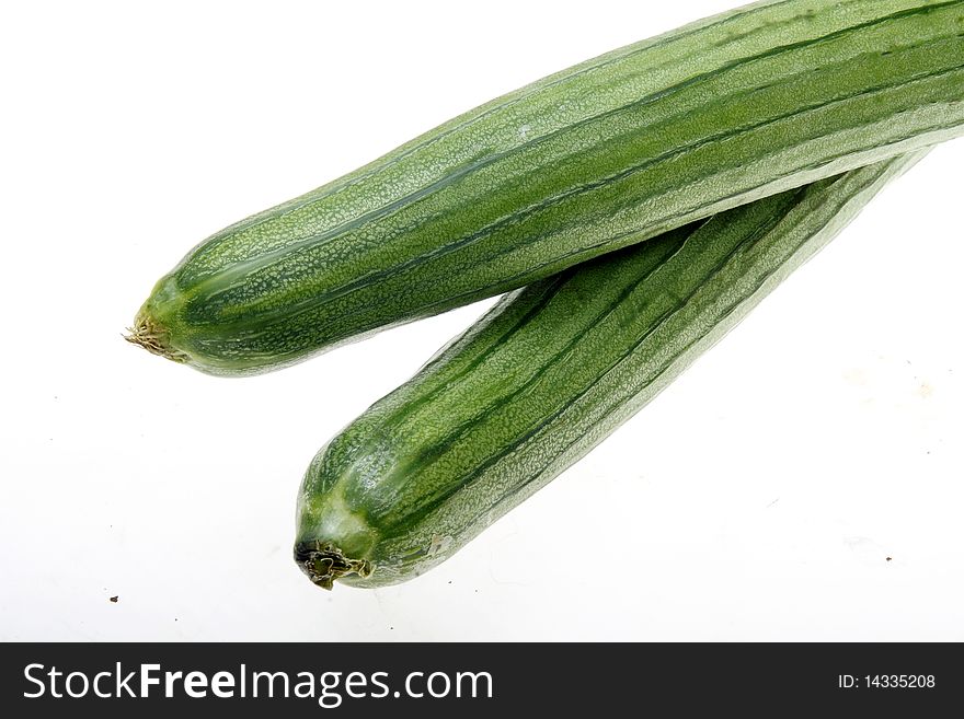 Close-up of fresh loofah isolated on white. It is very rich in nutritional value. It can not only edible, but also have medicinal value.(in traditional Chinese medicine)