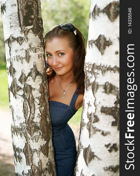 The beautiful girl near birches