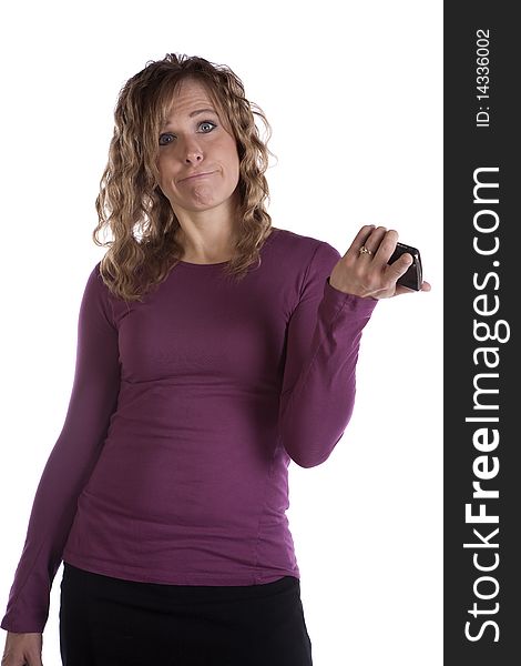 A woman in purple is holding her cell phone and making a funny expression. A woman in purple is holding her cell phone and making a funny expression.