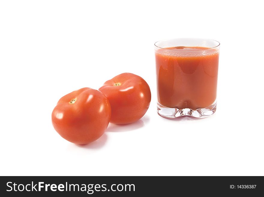 Fresh tomatoes and a glass full of tomato juice