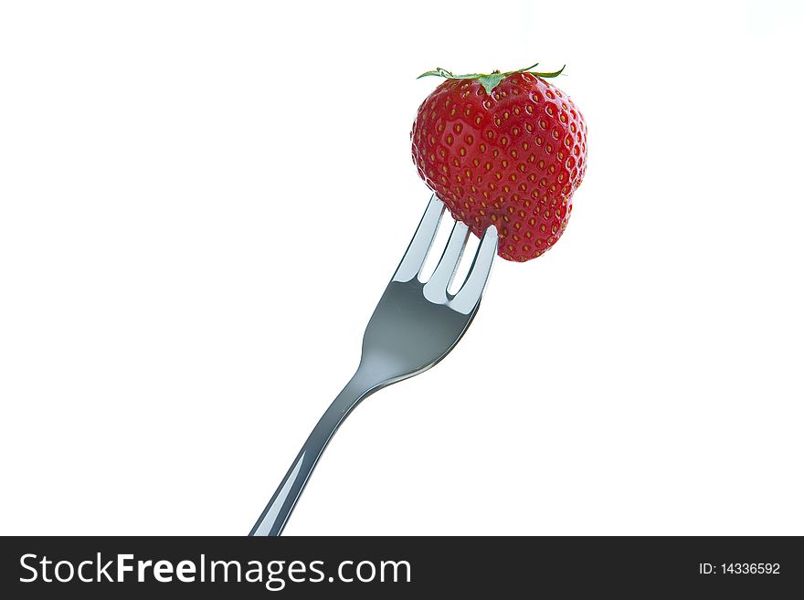 Single ripe fresh strawberry on fork isolated on white. Clipping path included