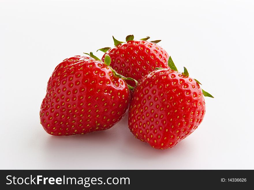 Group of ripe fresh strawberries isolated on white. Clipping path included. Group of ripe fresh strawberries isolated on white. Clipping path included