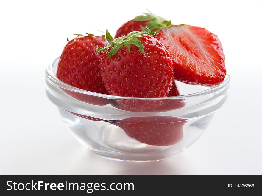 Group of ripe fresh strawberries in glass bowl isolated on white. Group of ripe fresh strawberries in glass bowl isolated on white