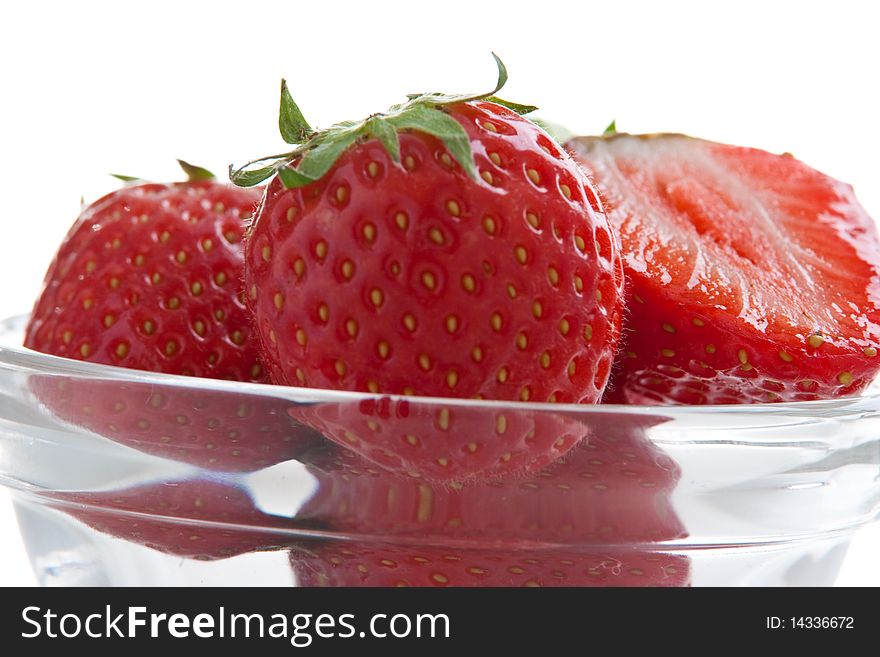 Group of ripe fresh strawberries in glass bowl isolated on white. Group of ripe fresh strawberries in glass bowl isolated on white