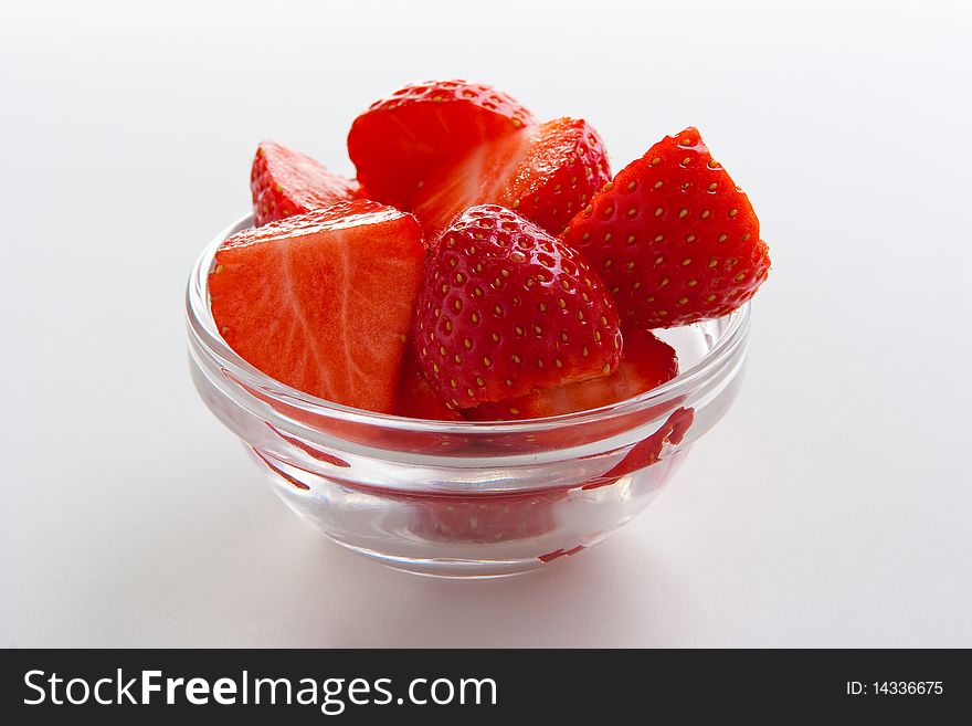 Group of ripe fresh strawberries in glass bowl isolated on white. Group of ripe fresh strawberries in glass bowl isolated on white