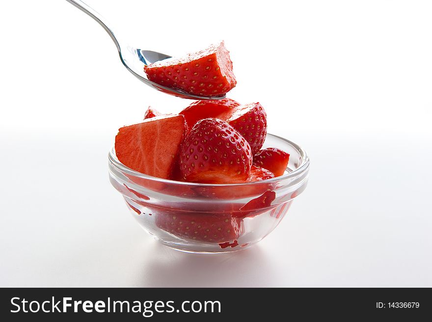 Group of ripe fresh strawberries in glass bowl isolated on white. Group of ripe fresh strawberries in glass bowl isolated on white