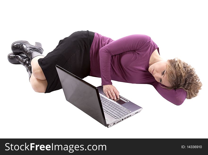 A woman in purple is laying by her computer with her hand on her computer. A woman in purple is laying by her computer with her hand on her computer.