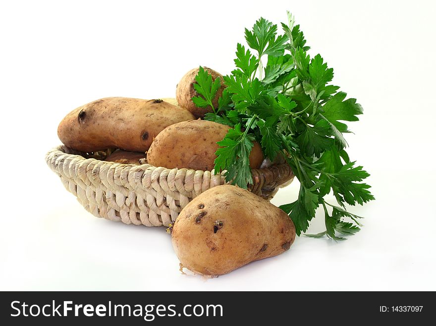 Fresh potatoes in a basket on a white background