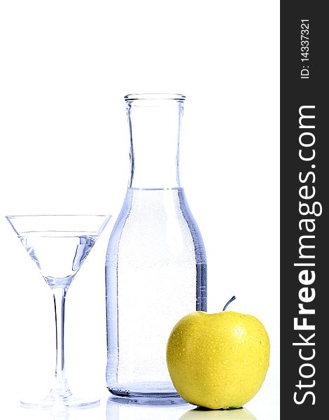 Bottle with transparent water, a glass and apples on a white background