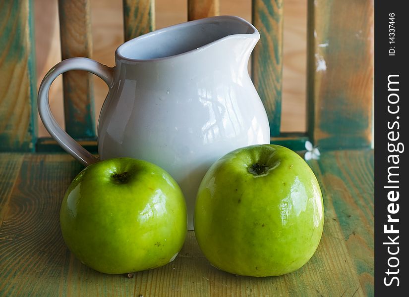 Two green apples and white  jug. Two green apples and white  jug