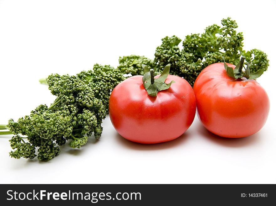 Refine tomatoes and parsley onto white background. Refine tomatoes and parsley onto white background