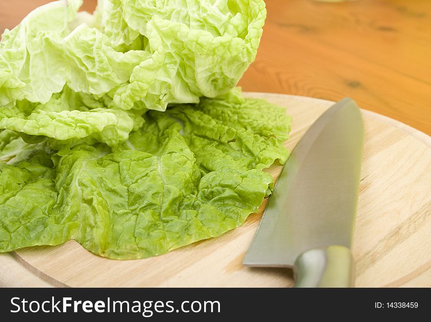 Beijing cabbage lay on a wooden board near a knife