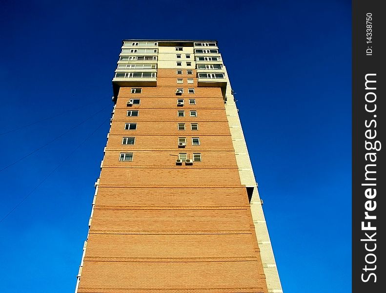 High building from a red brick against the sky. High building from a red brick against the sky