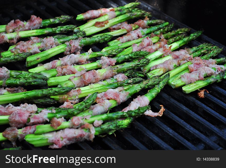 Fresh Asparagus wrapped in Pancetta Cooking on the Grill. Fresh Asparagus wrapped in Pancetta Cooking on the Grill