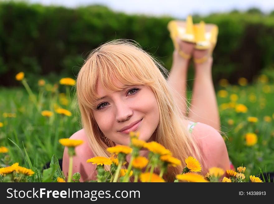 Young woman laying down in meadow