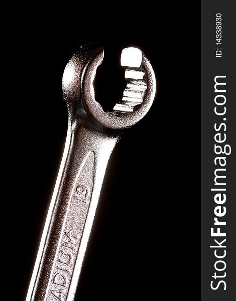 Tools series: steel wrench on black background