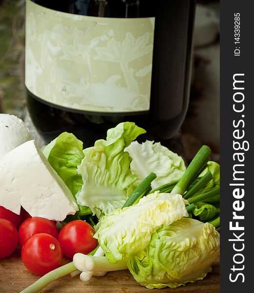 Fresh cheese, vegetables and bottle of red wine. Fresh cheese, vegetables and bottle of red wine