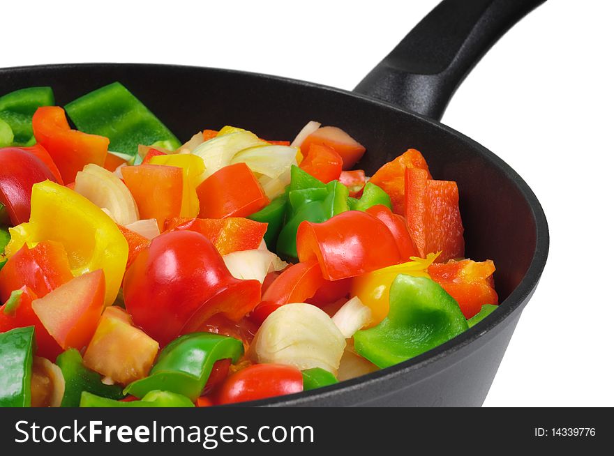 Roasting pan with the vegetables. Red and green peppers, onions, tomatoes. Isolated on white