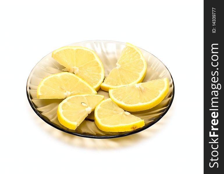 Lemon slices on plate isolated on white