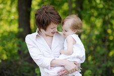 Young Mother Holding Her Adorable Girl Stock Images