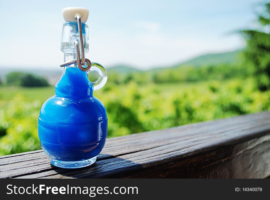 Small blue bottle full of liquid, Sky needs more blue. Small blue bottle full of liquid, Sky needs more blue