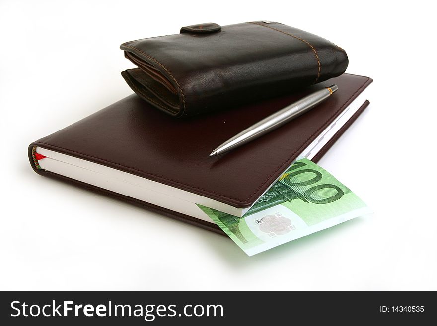 Banknote 100 euro in brown notebook, purse and pen on white background. Banknote 100 euro in brown notebook, purse and pen on white background