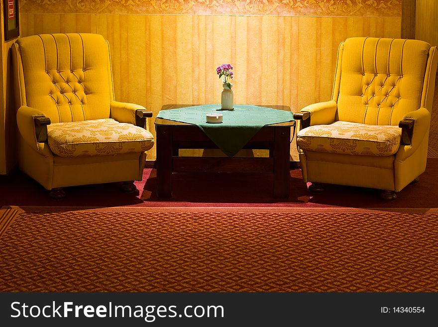 Two comfortable armchairs with a coffeetable in a hallway of a hotel. Two comfortable armchairs with a coffeetable in a hallway of a hotel