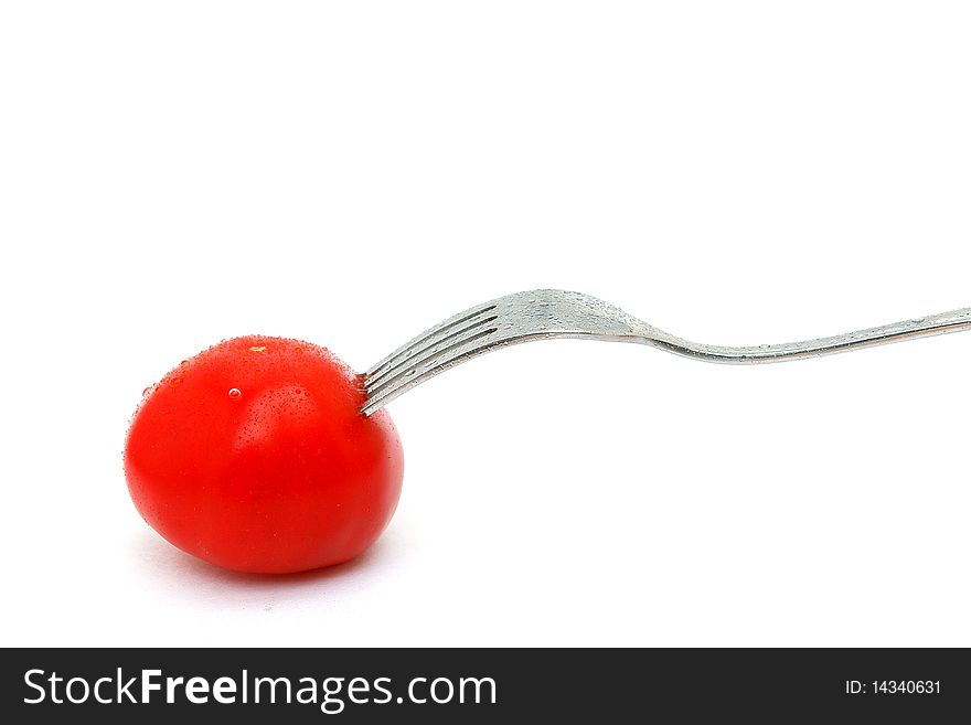 Picture of isolated tomato and fork with white background.