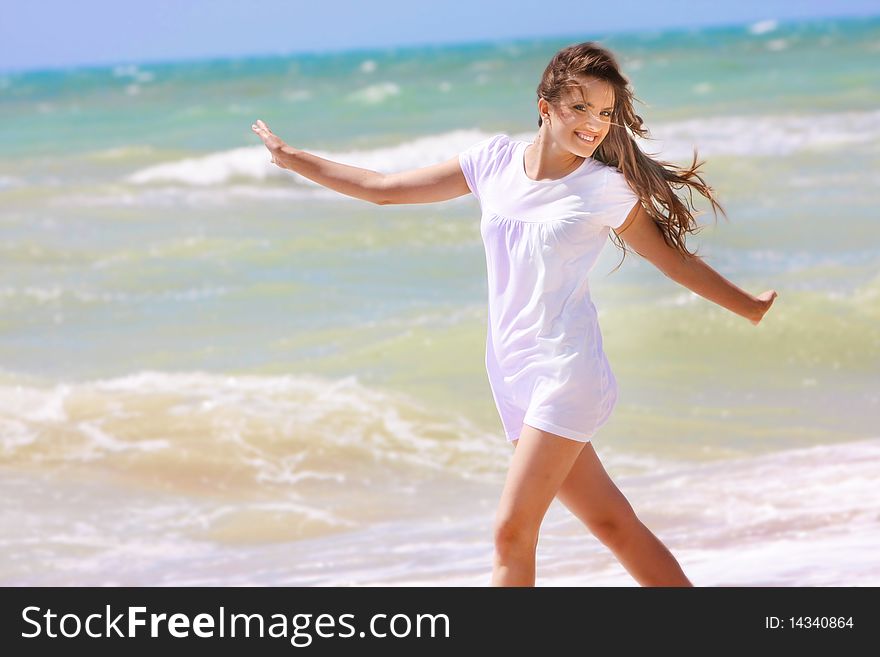 Young happy girl on sea background