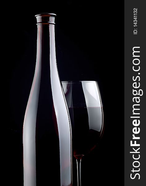 Bottle and glass on a black background. Bottle and glass on a black background