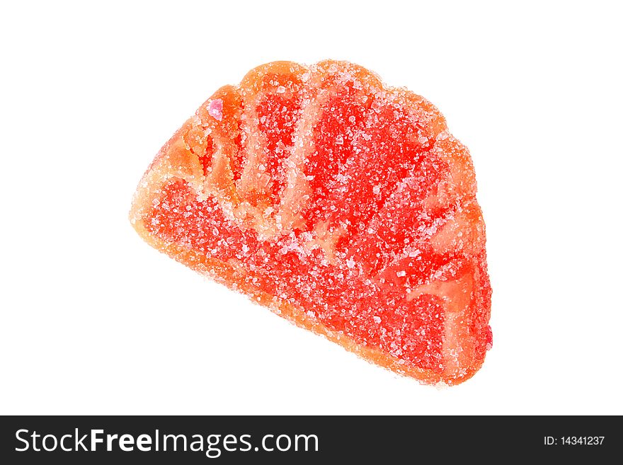 The sweet from fruit candy of orange colour is strewed by sugar.