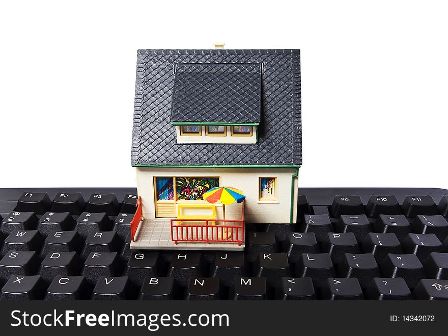 Model house with keyboard on white background