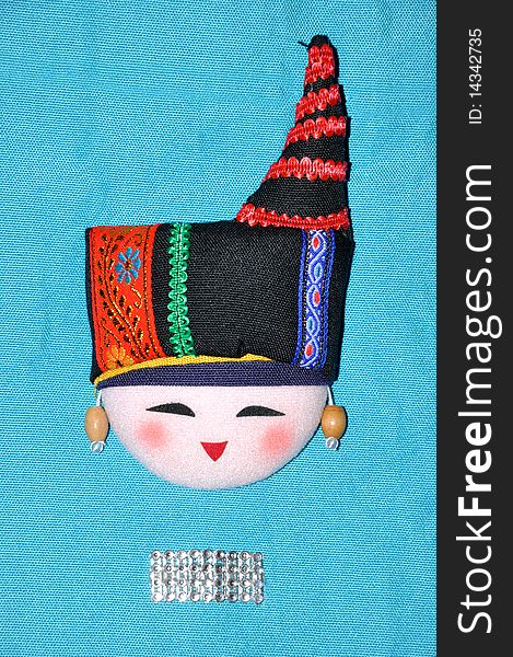 Finery embroidery doll of Chinese minority Chuang's tradtional style. The raiment and hat for men in feast day. Finery embroidery doll of Chinese minority Chuang's tradtional style. The raiment and hat for men in feast day.